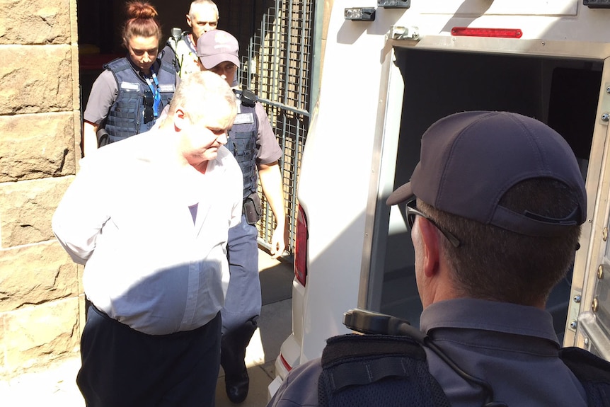 Peter Arthur is led from court to a police division van on April 3, 2017.