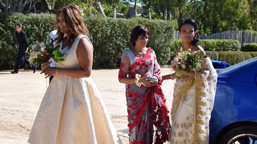 Kavindi arrives at her wedding with two other women.