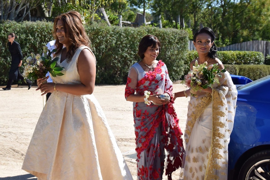 Kavindi arrives at her wedding with two other women.