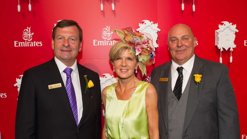 Foreign Minister Julie Bishop wears a fascinator as she stands with two Emirates Vice Presidents at the Melbourne Cup in 2014.