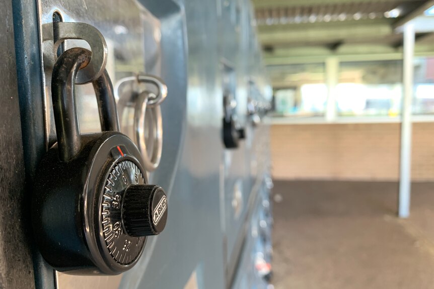 A close up shot of a combination lock on a school locker.