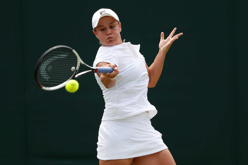 Ashleigh Barty plays a forehand from the baseline against Eugenie Bouchard at Wimbledon.