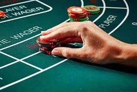 A hand on chips on a Baccarat table at Crown Casino in Melbourne.