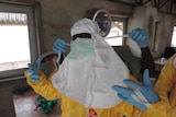 A health worker in Sierra Leone prepares for her shift in an ebola hospital.