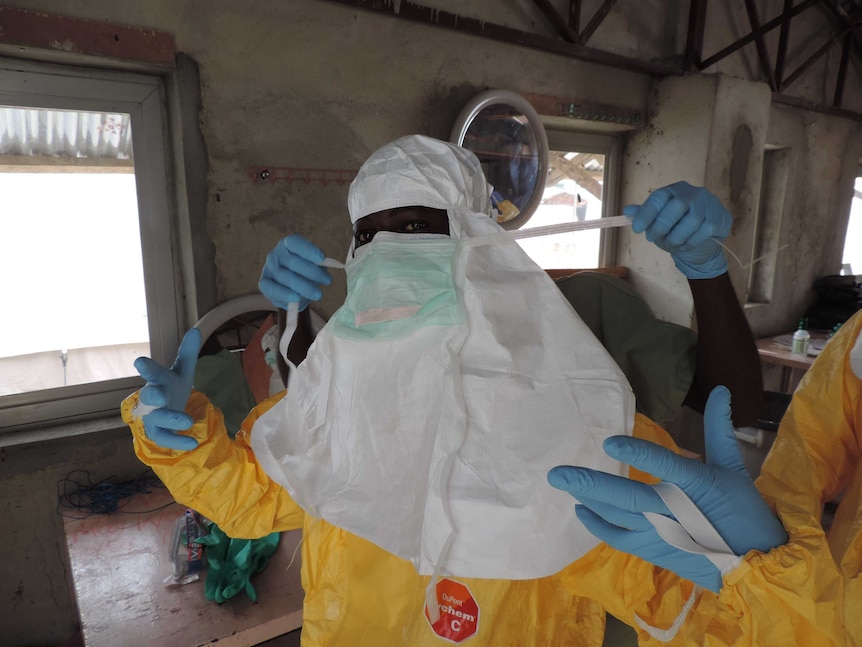 A health worker in Sierra Leone prepares for her shift in an ebola hospital.