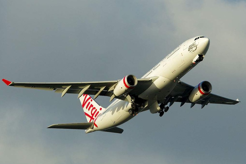 A Virgin plane flies nose upward after taking off.