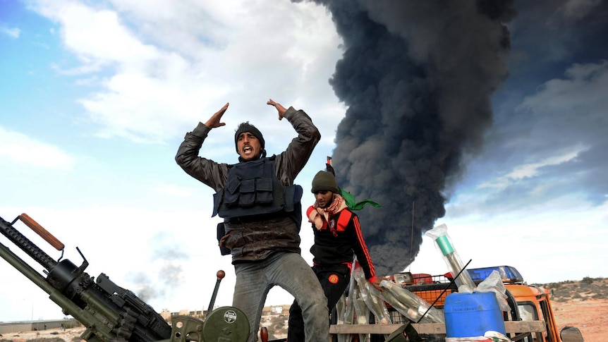 Libyan rebel fighters react during clashes with forces loyal to leader Moamar Gaddafi (AFP: Roberto Schmidt)