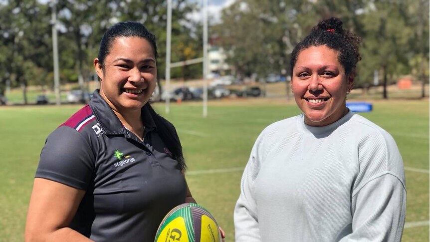 Liz Patu (left) and Alisi Qalo-Wilson (right) standing side by side. Alisi is holding a yellow rugby ball.