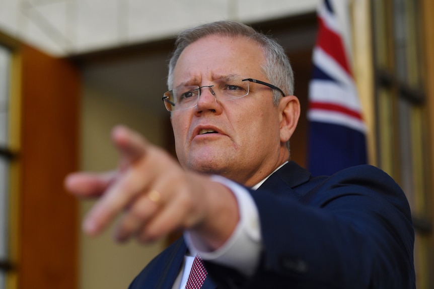 Scott Morrison pointing at a reporter during a press conference.