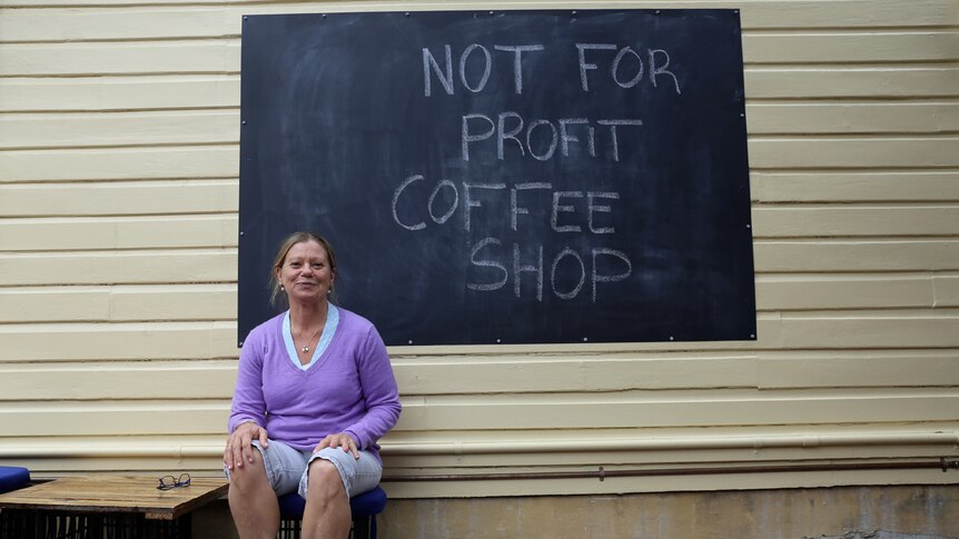 Sharon Sweeney next to coffee sign