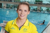 Taneka Kovchenko smiles while standing in front of pool.