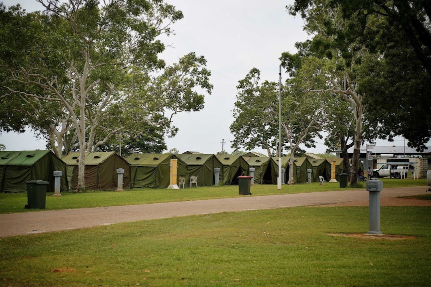 Green tents are set up on a Katherine field