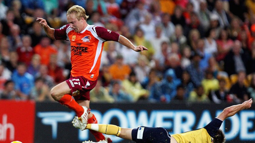 Mitchell Nichols of the Roar gets past the attempted tackle of Matthew Osman of the Mariners