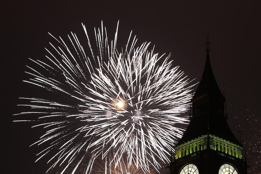 Fireworks explode behind the Big Ben clock.