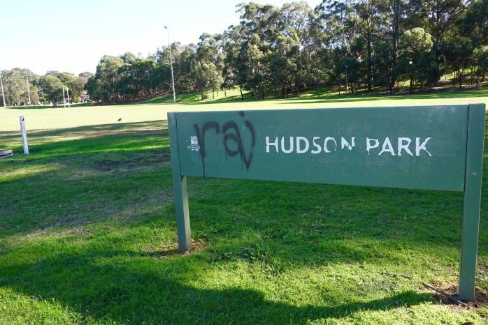 A sign of Hudson park in Newcastle with graffiti on it