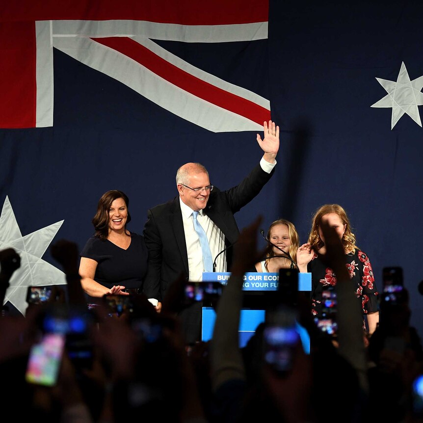 Scott Morrison raises his fist in celebration as he gives his victory speech