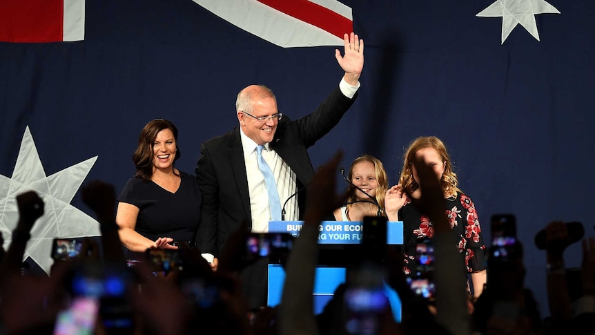 Scott Morrison raises his fist in celebration as he gives his victory speech