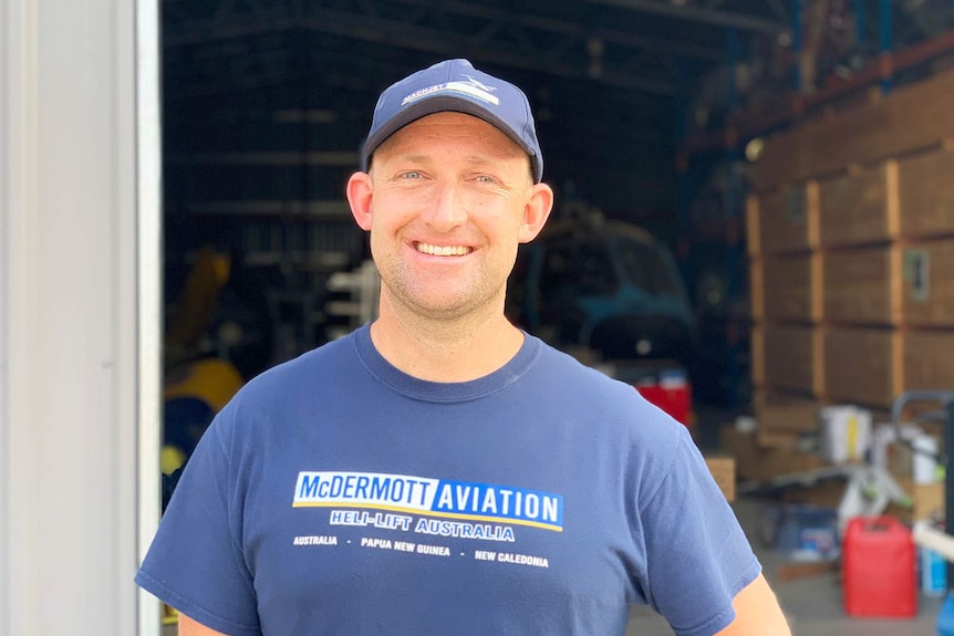 Simon McDermott stands outside a hangar at the McDermott Aviation base at Cooroy.