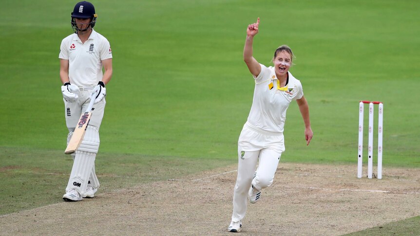Ellyse Perry points to the sky as she runs away from the pitch after a Test wicket against England.