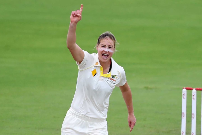 Ellyse Perry points to the sky as she runs away from the pitch after a Test wicket against England.