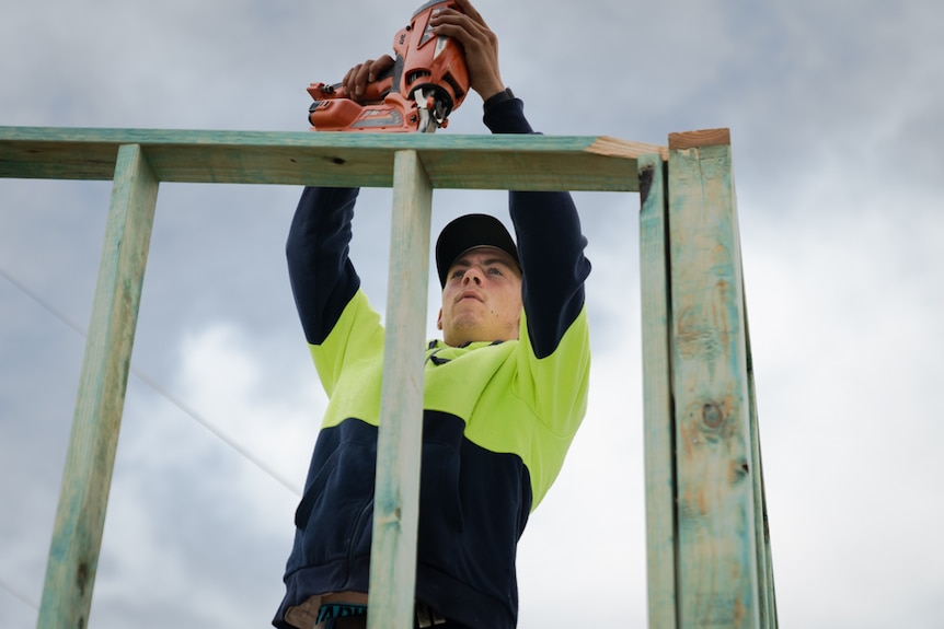 Apprentice using nail gun.