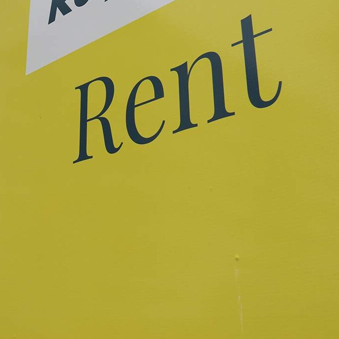 Rent sign of real estate agency outside an apartment building in Brisbane