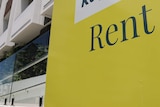Rent sign of real estate agency outside an apartment building