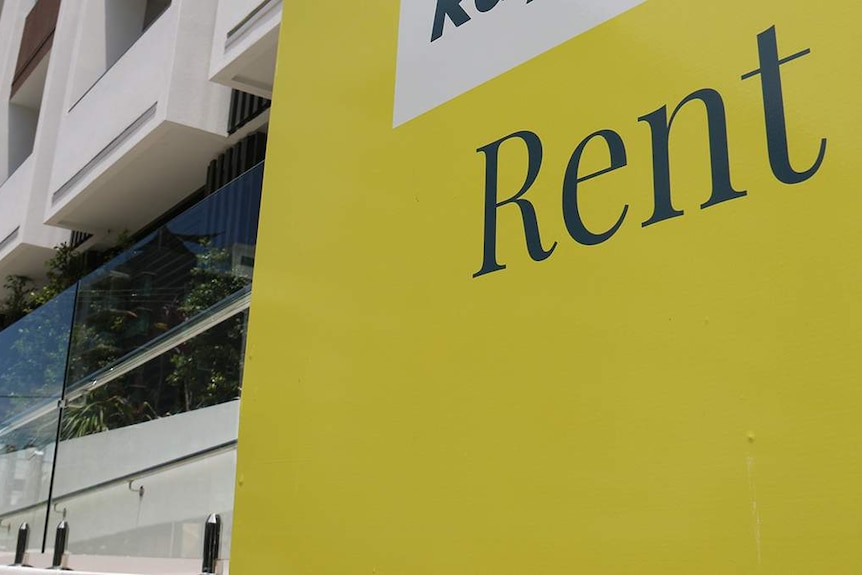 Rent sign of real estate agency outside an apartment building