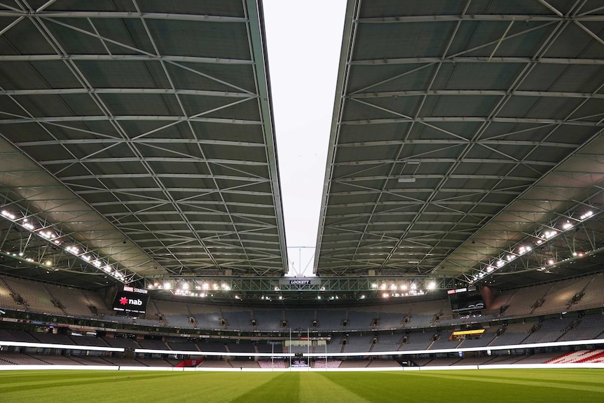 The roof at Melbourne's Docklands stadium is almost closed before an AFL match between St Kilda and the Western Bulldogs.