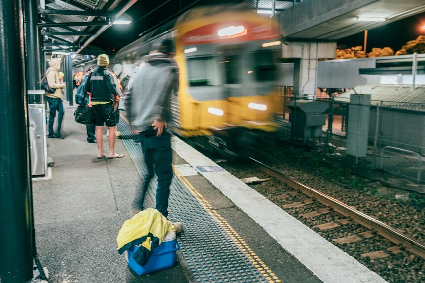 A train arrived at Woy Woy station at 4:45am as commuters line up
