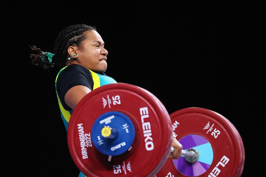 Eileen Cikamatana performs a clean and jerk