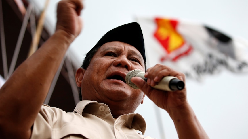 Prabowo Subianto speaks into a microphone. 