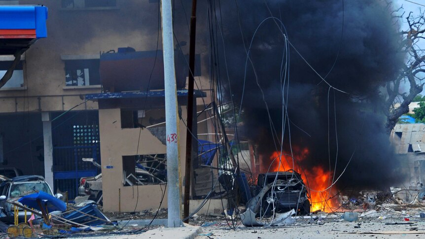 Fire is seen at the scene of a car bomb attack claimed by Shabaab militants which killed at least 5 people in Mogadishu.