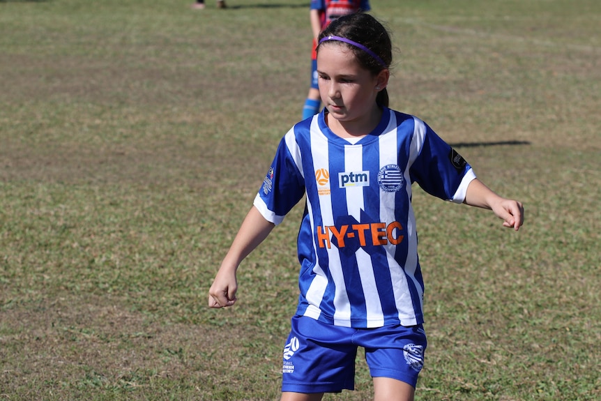 Junior soccer player Indi plays a game in Darwin.