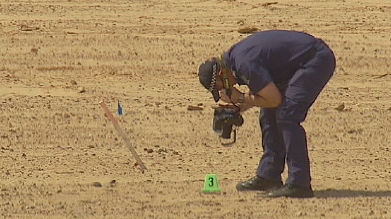 Policeman searching for bones