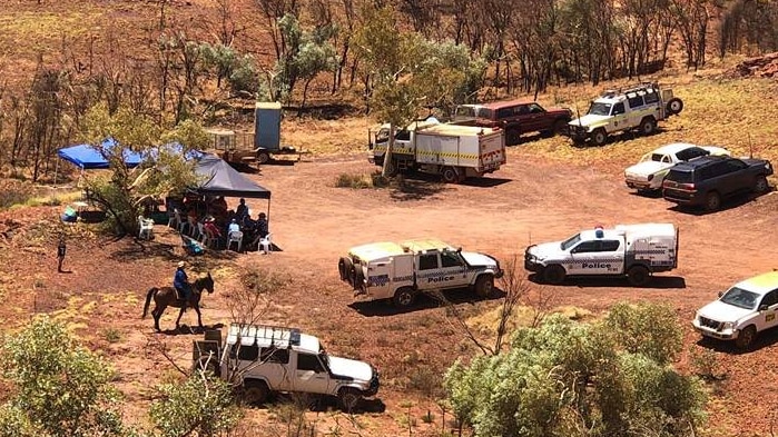 Emergency vehicles and a horse at the headquarters of the Tom Price search