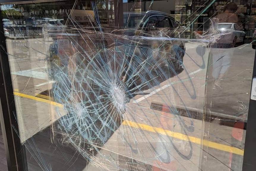 A cracked window at a liquor shop 