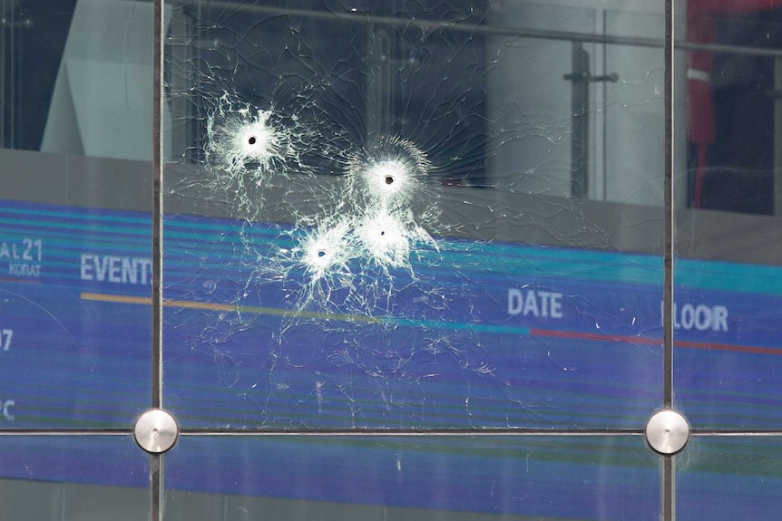 Bullet holes in the window of a Thai shopping mall.