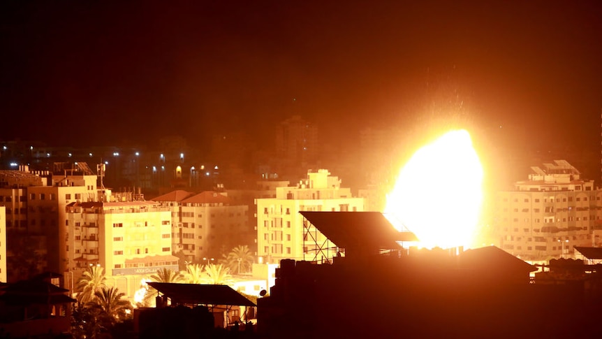 Fire and smoke rise above buildings in Gaza City as Israeli warplanes target the Palestinian enclave.