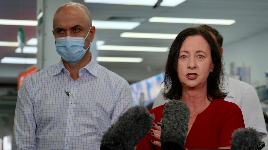 Qld Health Minister Yvette D'Ath and Chief Health Officer John Gerrard speak to reporters