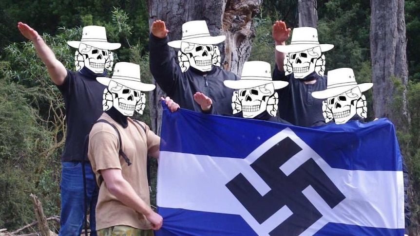 A group of young men perform a Nazi salute around a blue and white striped flag with a swastika