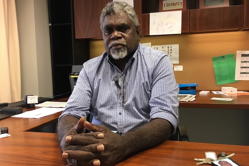 MLA Yingiya Guyula sitting, looking concerned at his desk.