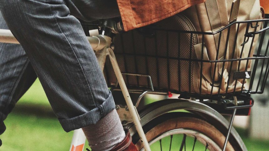 Close up of man wearing dress shoes on a commuter bike