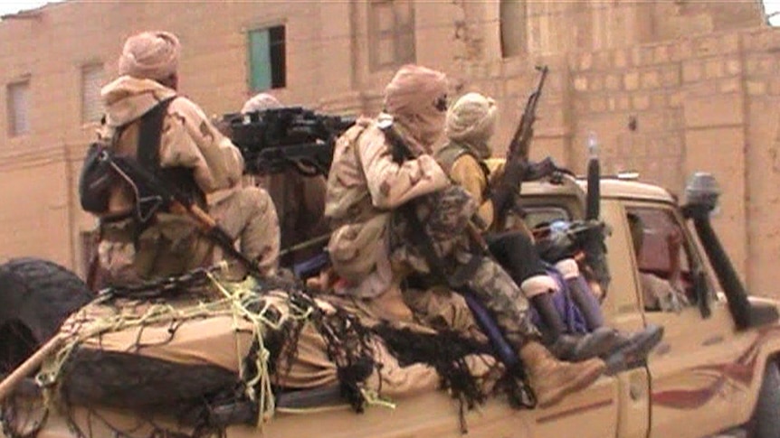 A pick up truck carries rebel fighters from the Islamist group Ansar Dine in Timbuktu.