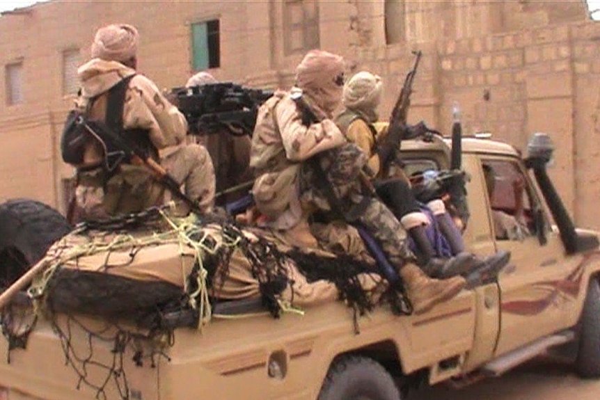 A pick up truck carries rebel fighters from the Islamist group Ansar Dine in Timbuktu.