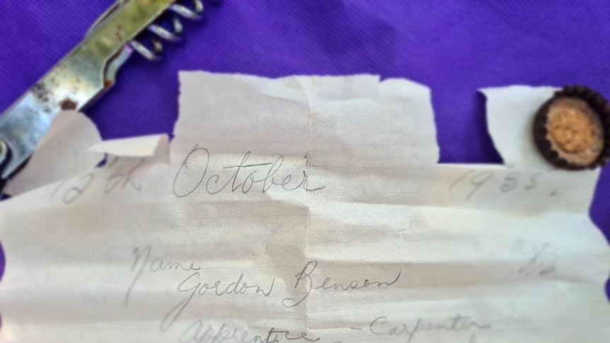 A slightly torn and worn note. 