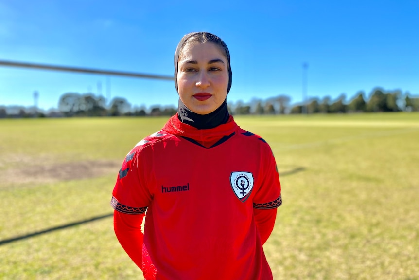 Afghanistan women's soccer team player Mursal Sadat standing on the field looking at the the camera
