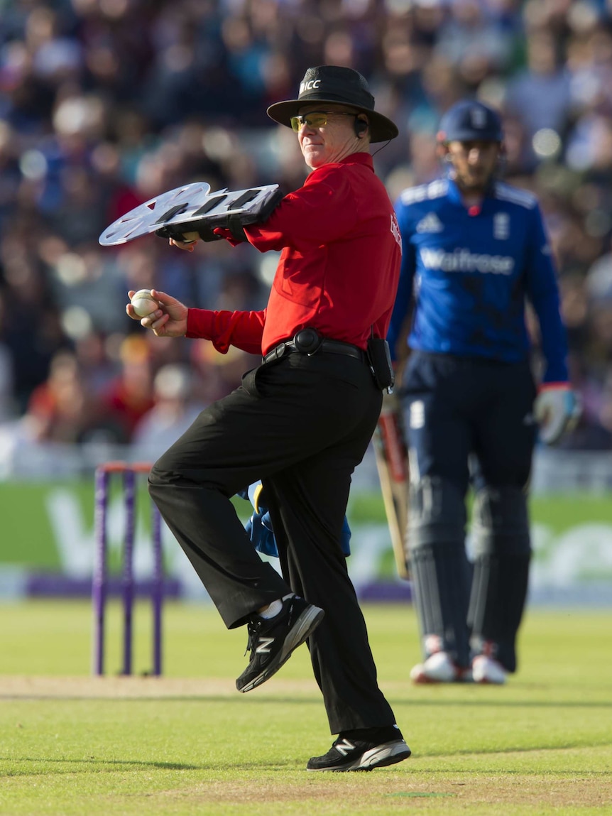 Umpire Bruce Oxenford with arm shield