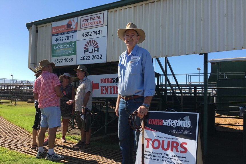 Retired grazier Geoff Thompson with his sign advertising tours at the Roma Saleyards