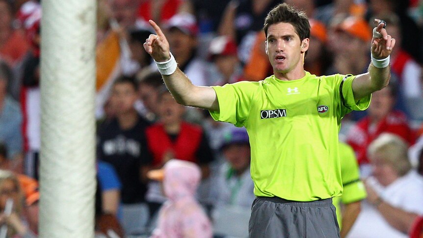File photo of AFL umpire signalling for video review